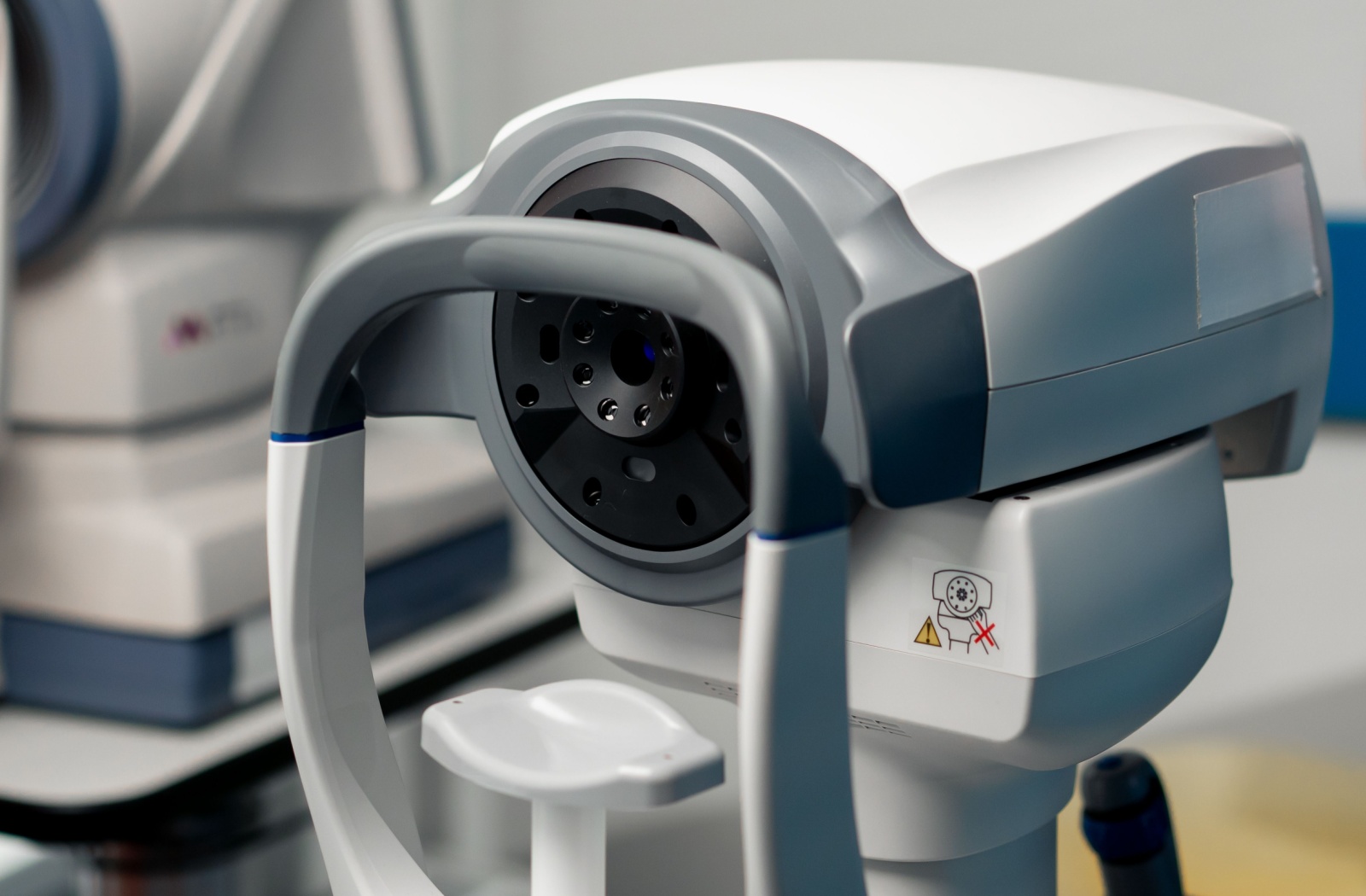 A close up of an a diagnostic imaging device at an optometry office.