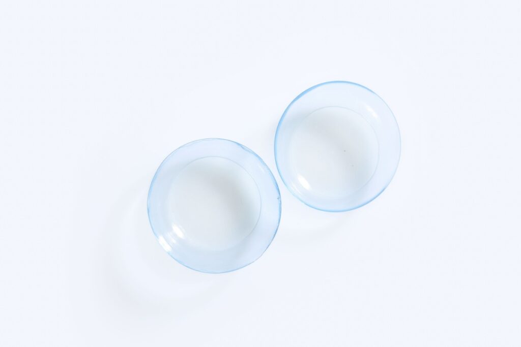 Pair of contact lenses against a white background.